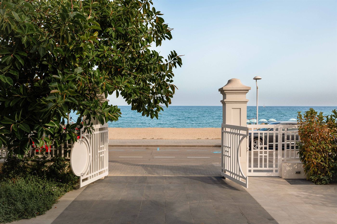 The hotel gate open onto the promenade, with the sand and sea directly beyond